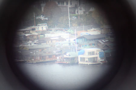 Houses by water through telescope